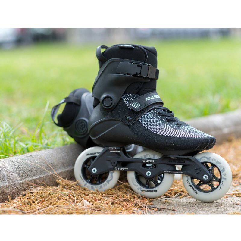 Powerslide Swell Lite Black 1OO Inline Skate, outdoors with a grassy field in the background
